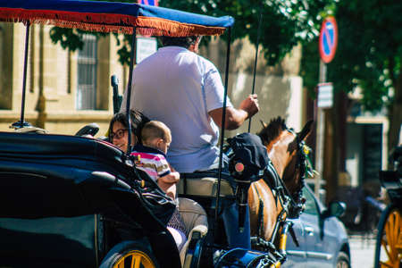 Seville Spain July 06, 2021 Horse drawn carriage ride through Seville. Travel through the historic center of Seville and during the carriage ride people will be able to contemplate the main monumentsの写真素材