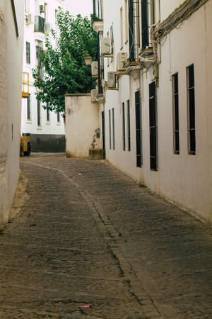 Carmona Spain July 14, 2021 Narrow street in town of Carmona called The Bright Star of Europe, the town shows a typical narrow and meandering Arabic layout which will transport you to a distant pastの写真素材