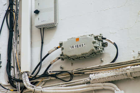Carmona Spain July 16, 2021 Electric cables on the facade of a building in the streets of Carmona, the town shows a typical narrow and meandering Arabic layoutの写真素材