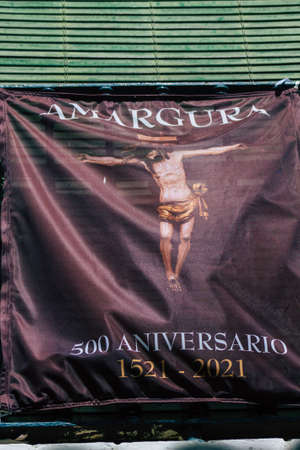 Carmona Spain July 14, 2021 Religious poster at the window of a old house in the narrow streets in...