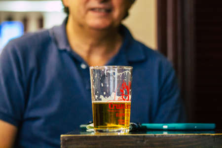 Carmona Spain July 15, 2021 Unidentified tourist without face mask drinking a glass en having fun in summertime at Al Angelus Divinoteca, a unique tapas bar located inside the old Carmona food marketのeditorial素材