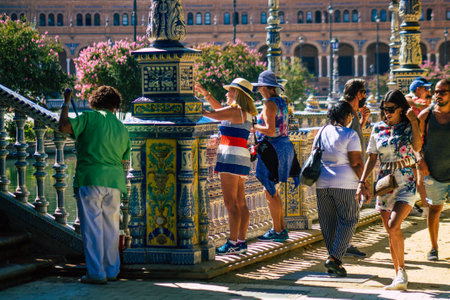 Seville Spain July 09, 2021 Tourists visiting Maria Luisa Park, the first urban park and one of the green lungs of Seville, emblematic city and capital of the Andalusia regionのeditorial素材