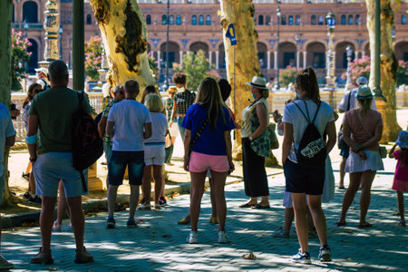 Seville Spain July 09, 2021 Tourists visiting Maria Luisa Park, the first urban park and one of the green lungs of Seville, emblematic city and capital of the Andalusia regionのeditorial素材