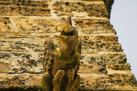 Carmona Spain July 15, 2021 Closeup of gargoyle on the exterior facade of the Church of Santa Maria...