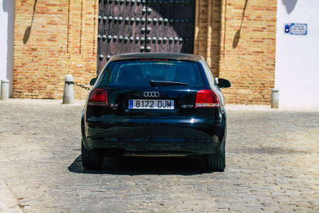 Carmona Spain July 14, 2021 Cars rolling in a narrow street in Carmona, an emblematic city and the capital of the region of Andalusia, in the south of Spainのeditorial素材
