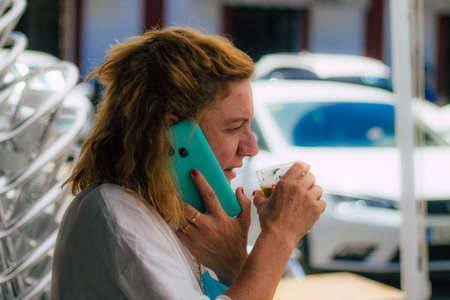 Carmona Spain July 15, 2021 Unidentified tourist without face mask drinking a glass en having fun in summertime at Al Angelus Divinoteca, a unique tapas bar located inside the old Carmona food marketのeditorial素材