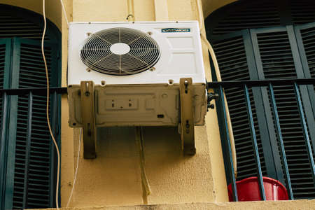 Carmona Spain July 14, 2021 AC on the facade of a building in the streets of Carmona, the town shows a typical narrow and meandering Arabic layoutのeditorial素材