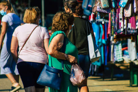 Carmona Spain July 19, 2021 Unidentified Spanish people with face mask shopping at local market in downtown during Coronavirus outbreak hitting Spain, wearing a mask is mandatoryのeditorial素材