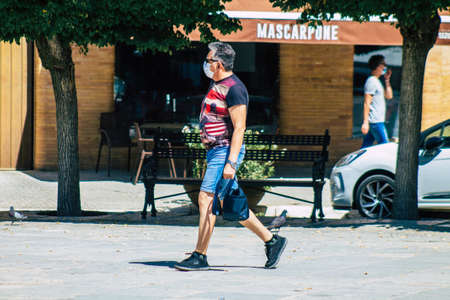Carmona Spain July 24, 2021 Pedestrian walking in the streets of Carmona during the coronavirus outbreak hitting Spain, wearing a mask is not mandatory but most of people wear itのeditorial素材