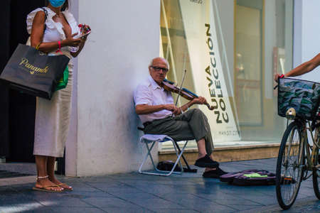 Seville Spain July 23, 2021 People playing music in the street of Seville during coronavirus outbreak hitting Spain, wearing a mask in the street is not mandatory but most of people wear itのeditorial素材
