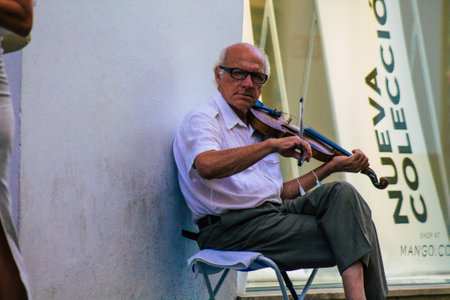 Seville Spain July 23, 2021 People playing music in the street of Seville during coronavirus outbreak hitting Spain, wearing a mask in the street is not mandatory but most of people wear itのeditorial素材