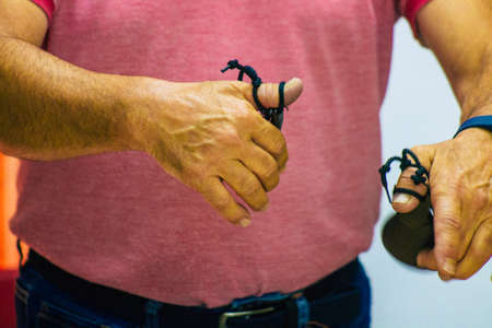 Seville Spain July 23, 2021 Closeup of the hands of castanets players, favorite musical instrument of flamenco dancers in Spain, gives rhythm and accompanies singingのeditorial素材