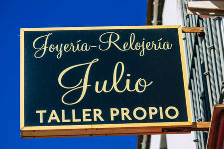 Carmona Spain July 26, 2021 Commercial sign front a business located in Carmona, a old city called The Bright Star of Europe, the town shows a typical narrow and meandering Arabic layoutのeditorial素材