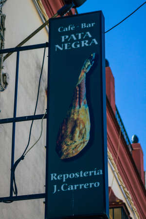 Carmona Spain July 26, 2021 Commercial sign front a business located in Carmona, a old city called The Bright Star of Europe, the town shows a typical narrow and meandering Arabic layoutのeditorial素材