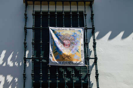 Carmona Spain July 30, 2021 Religious poster at the facade of a old house in the narrow streets in town of Carmona, the town shows a typical narrow and meandering Arabic layoutのeditorial素材