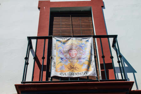 Carmona Spain July 30, 2021 Religious poster at the facade of a old house in the narrow streets in town of Carmona, the town shows a typical narrow and meandering Arabic layoutのeditorial素材