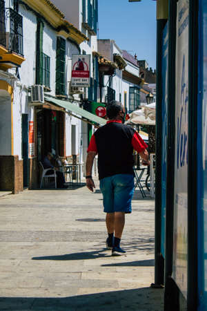 Carmona Spain July 30, 2021 Pedestrian walking in the streets of Carmona during the coronavirus outbreak hitting Spain, wearing a mask is not mandatory but most of people wear itのeditorial素材
