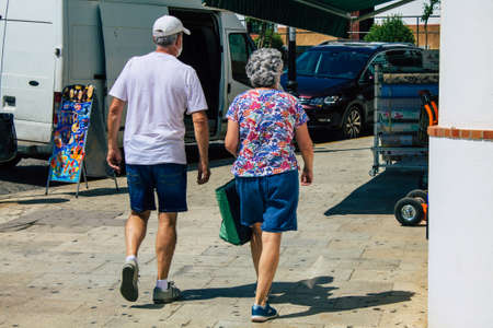 Carmona Spain July 30, 2021 Pedestrian walking in the streets of Carmona during the coronavirus outbreak hitting Spain, wearing a mask is not mandatory but most of people wear itのeditorial素材