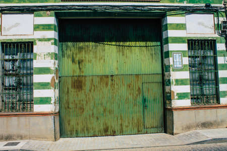 Carmona Spain July 31, 2021 Closeup of a door of old house in the narrow streets in town of Carmona called The Bright Star of Europe, the town shows a typical narrow and meandering Arabic layoutの写真素材