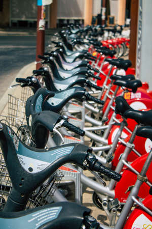 Seville Spain August 11, 2021 Accessible bicycles to hire for short periods of time, usually for a few hours parked in the street and part of the public transport system of Sevilleの写真素材