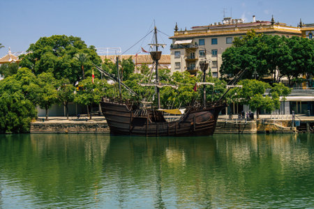 Seville Spain August 21, 2021 Tourist boats on the Guadalquivir River that crosses Seville, an emblematic city and the capital of the region of Andalusiaの写真素材