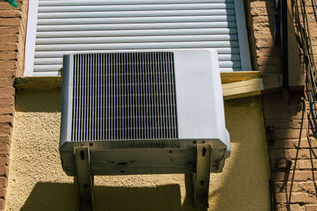 Seville Spain August 21, 2021 AC on the facade of a building in the streets of Seville, an...