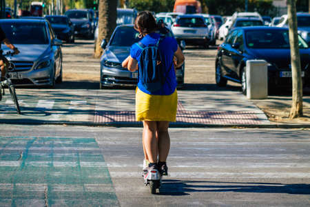 Seville Spain September 04, 2021 People rolling with an electric scooter in the streets of Seville,...
