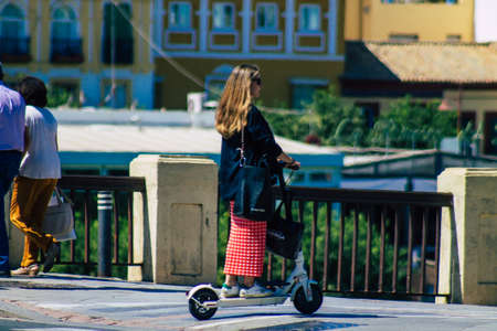 Seville Spain September 04, 2021 People rolling with an electric scooter in the streets of Seville,...