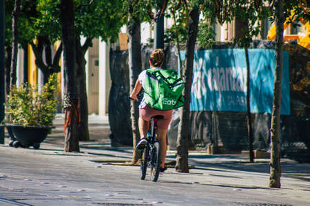 Seville Spain September 04, 2021 People rolling with a bicycle in the streets of Seville, an emblematic city and the capital of the region of Andalusia, in the south of Spainの写真素材