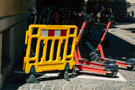 Seville Spain September 04, 2021 Electric scooter to rent parked in the streets of Seville, operating with a small utility internal combustion engines and a deck in the centerの写真素材