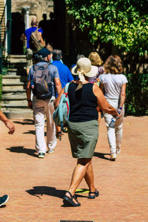 Seville Spain September 04, 2021 Tourists visiting The Alcazar of Seville and its gardens,...