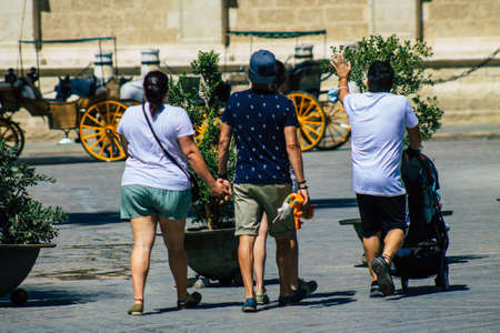 Seville Spain September 04, 2021 Pedestrians walking in the street during the coronavirus outbreak hitting Spain, wearing a mask is not mandatory but most of people wear itのeditorial素材