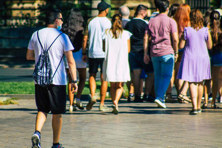Seville Spain September 04, 2021 Pedestrians walking the street on a zebra crossing during the coronavirus outbreak hitting Spain, wearing a mask is not mandatory but most people wear itのeditorial素材