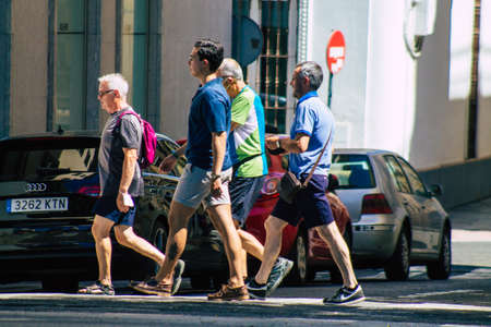 Seville Spain September 04, 2021 Pedestrians walking the street on a zebra crossing during the...