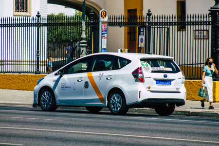 Seville Spain September 04, 2021 Taxi driving through the streets of Seville during the coronavirus outbreak hitting Spain, wearing a mask is mandatoryのeditorial素材