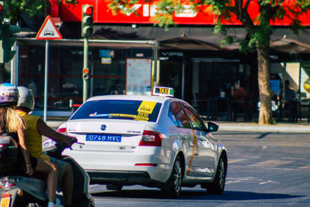 Seville Spain September 04, 2021 Taxi driving through the streets of Seville during the coronavirus outbreak hitting Spain, wearing a mask is mandatoryのeditorial素材