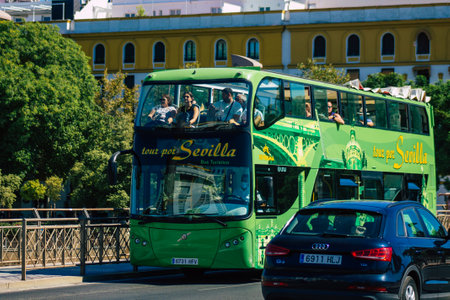Seville Spain September 04, 2021 Tourist bus driving through the streets of Seville during the coronavirus outbreak hitting Spain, wearing a mask is mandatoryのeditorial素材