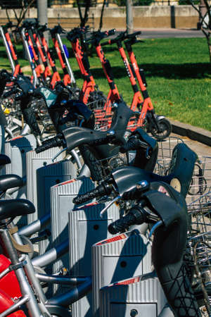 Seville Spain September 22, 2021 Electric scooter to rent parked in the streets of Seville, operating with a small utility internal combustion engines and a deck in the centerの写真素材