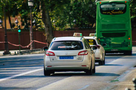Seville Spain September 15, 2021 Taxi driving through the streets of Seville during the coronavirus outbreak hitting Spain, wearing a mask is mandatoryのeditorial素材