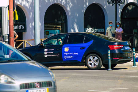 Seville Spain September 18, 2021 Taxi driving through the streets of Seville during the coronavirus outbreak hitting Spain, wearing a mask is mandatoryのeditorial素材