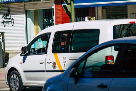 Seville Spain September 18, 2021 Taxi driving through the streets of Seville during the coronavirus outbreak hitting Spain, wearing a mask is mandatoryのeditorial素材
