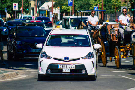 Seville Spain September 18, 2021 Taxi driving through the streets of Seville during the coronavirus outbreak hitting Spain, wearing a mask is mandatoryのeditorial素材