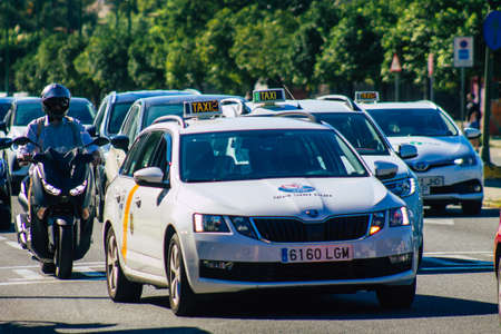 Seville Spain September 18, 2021 Taxi driving through the streets of Seville during the coronavirus outbreak hitting Spain, wearing a mask is mandatoryのeditorial素材