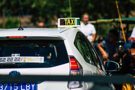 Seville Spain September 18, 2021 Taxi driving through the streets of Seville during the coronavirus outbreak hitting Spain, wearing a mask is mandatoryのeditorial素材