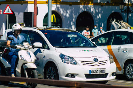 Seville Spain September 18, 2021 Taxi driving through the streets of Seville during the coronavirus outbreak hitting Spain, wearing a mask is mandatoryのeditorial素材