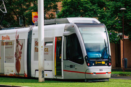 Seville Spain September 15, 2021 Modern electric tram for passengers rolling through the streets of Seville during the coronavirus outbreak hitting Spain, wearing a mask is mandatoryのeditorial素材
