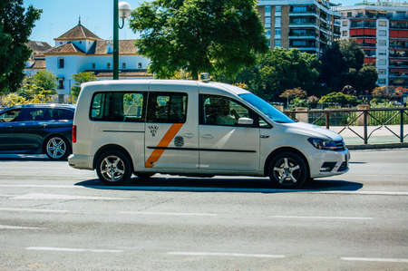 Seville Spain September 18, 2021 Taxi driving through the streets of Seville during the coronavirus outbreak hitting Spain, wearing a mask is mandatoryのeditorial素材