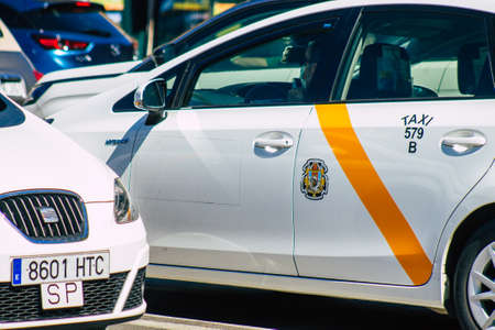 Seville Spain September 18, 2021 Taxi driving through the streets of Seville during the coronavirus outbreak hitting Spain, wearing a mask is mandatoryのeditorial素材