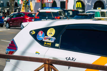 Seville Spain September 18, 2021 Taxi driving through the streets of Seville during the coronavirus outbreak hitting Spain, wearing a mask is mandatoryのeditorial素材