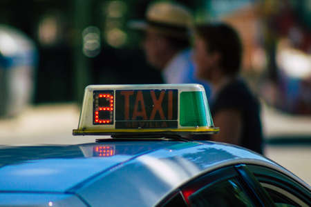 Seville Spain September 18, 2021 Taxi driving through the streets of Seville during the coronavirus outbreak hitting Spain, wearing a mask is mandatoryのeditorial素材